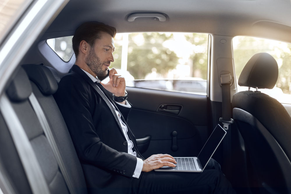 Man On Computer In Car